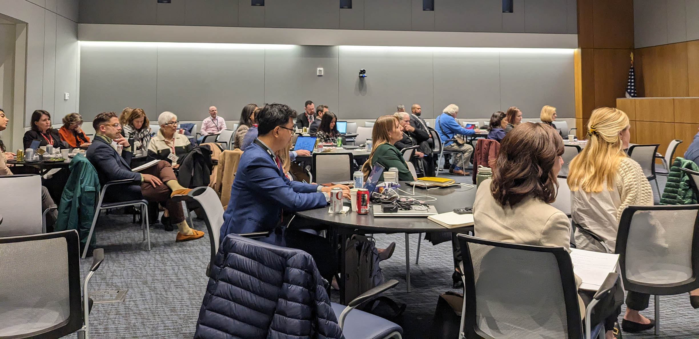 Image showing a conference audience sitting aroun round tables.