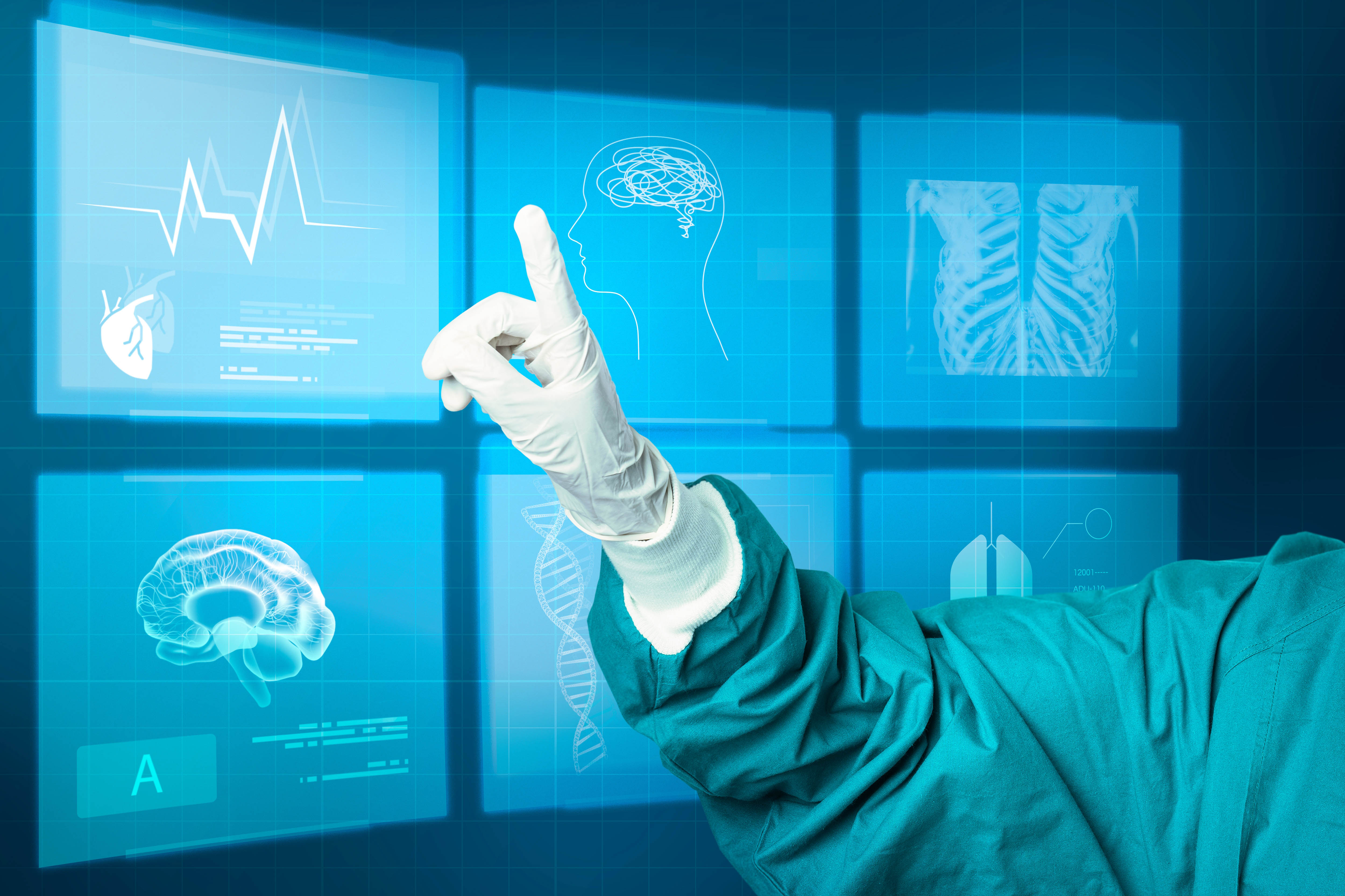 Image of a medical professional pointing at a group of digital screens