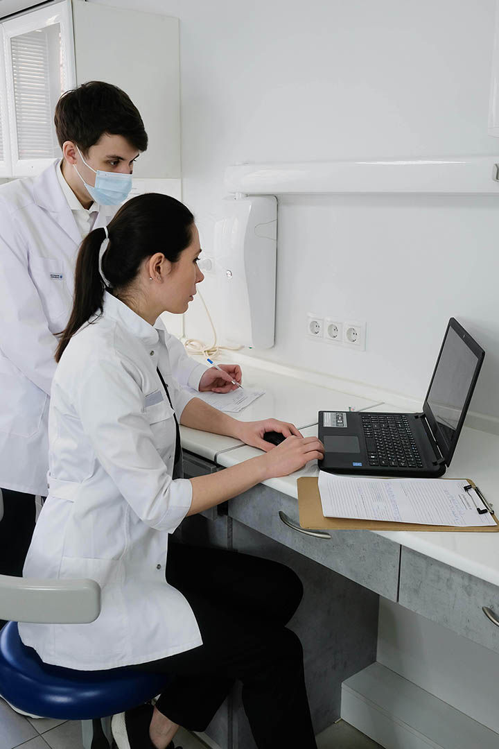 Two physicians looking into a digital screen