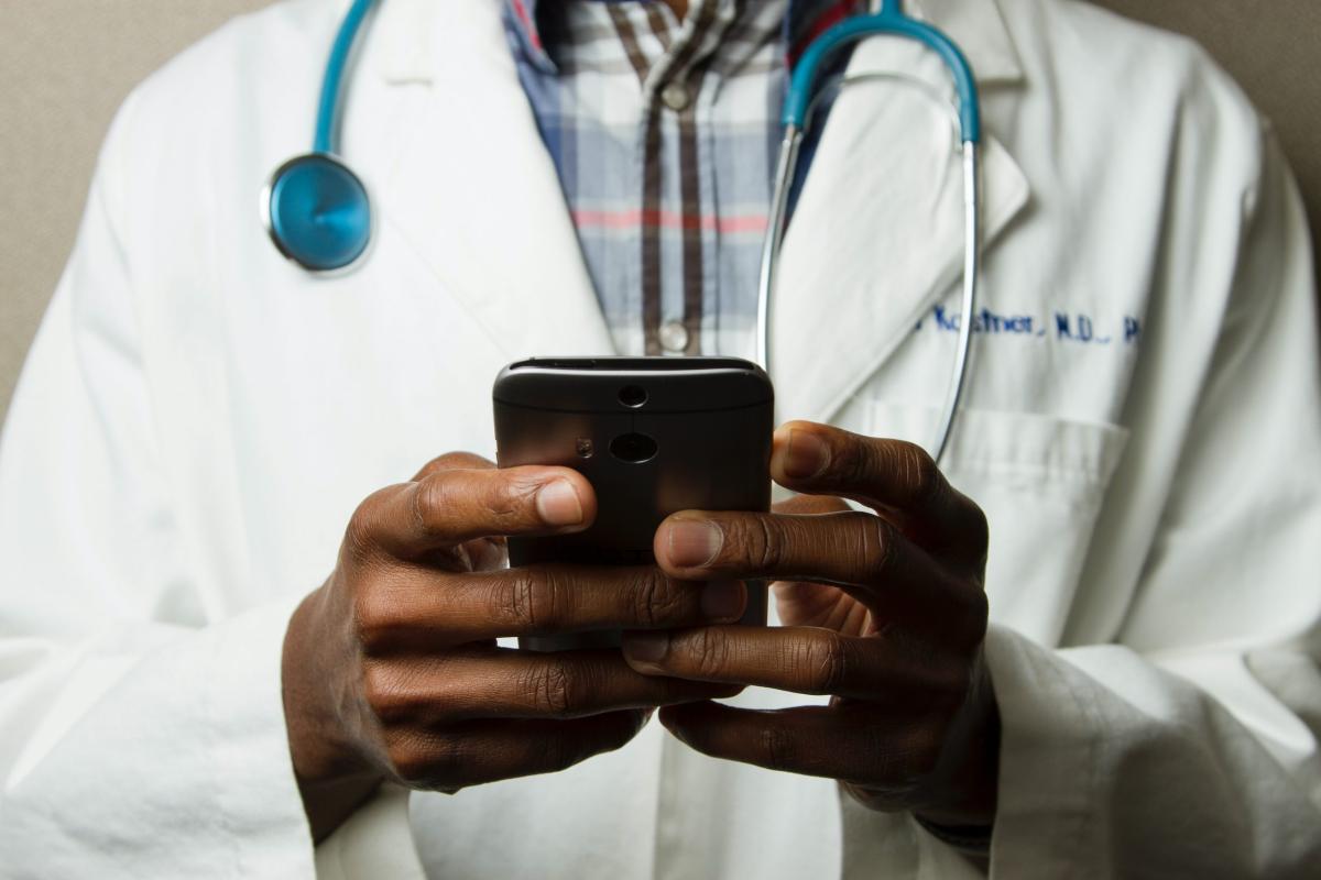 Doctor holding smart phone