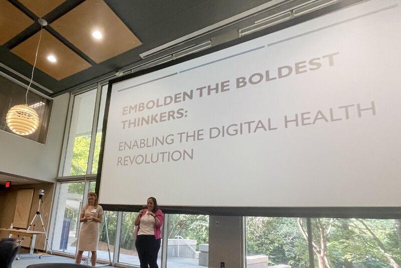Two people on stage giving a talk