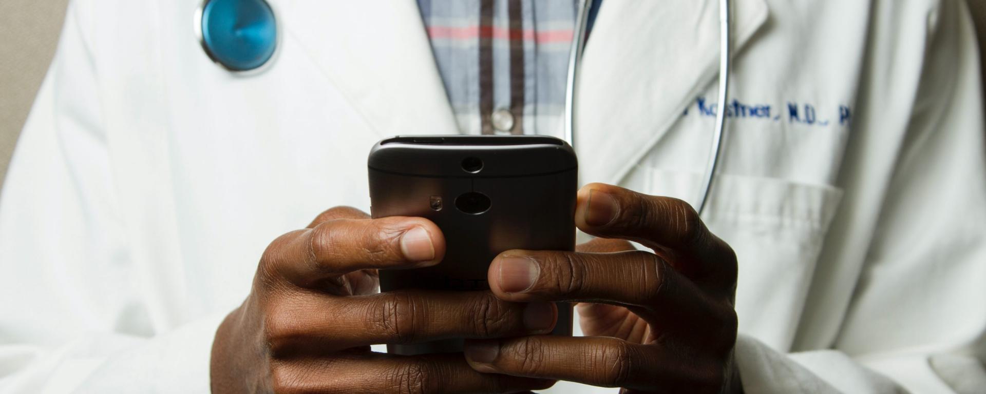 Doctor holding smart phone