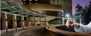 Duke University Hospital at night with a hand pointing at an AI interface