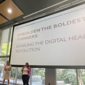 Two people on stage giving a talk