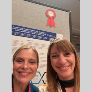 Nicoleta Economou and another woman in front of a research poster
